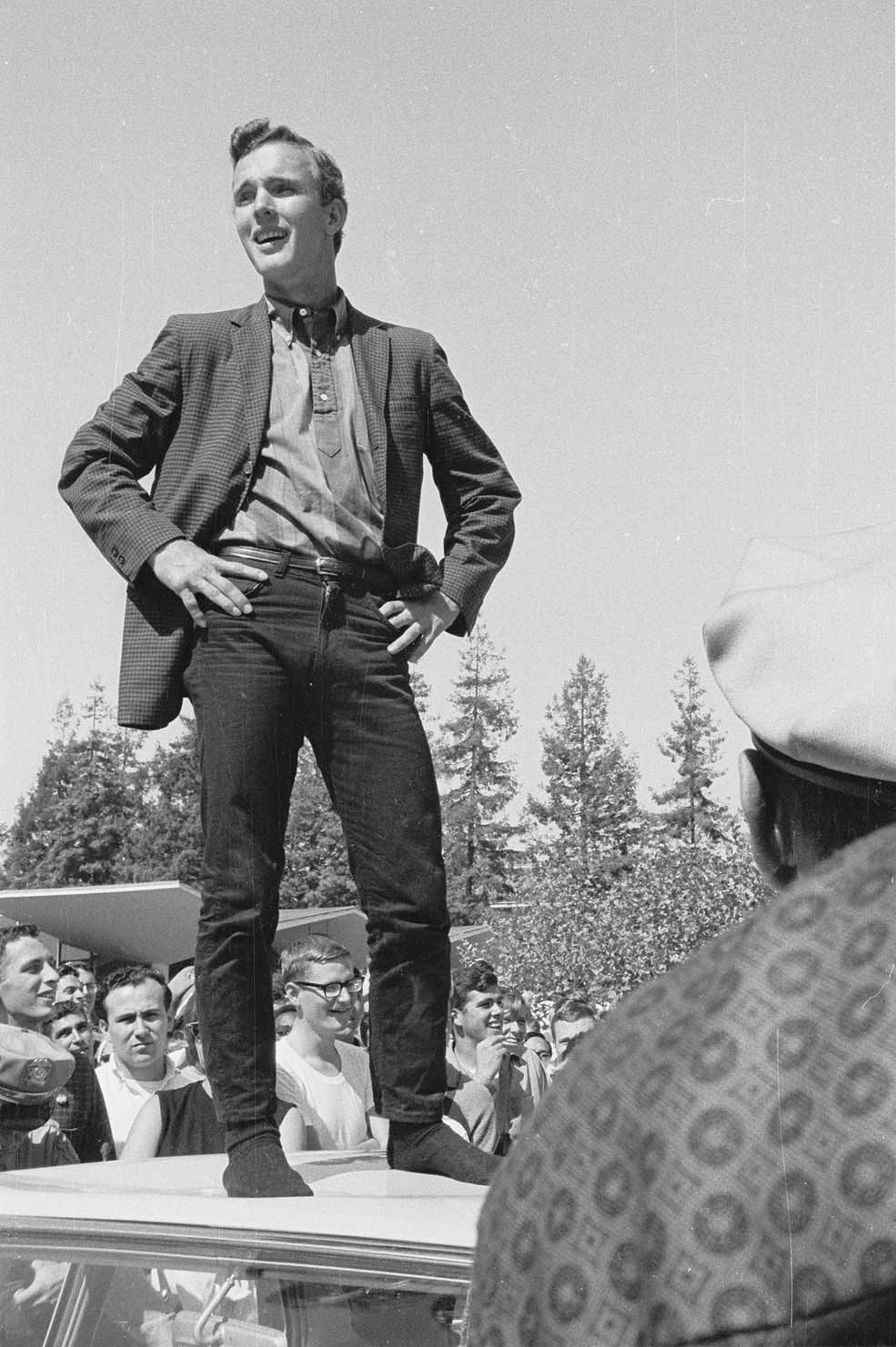 Brian Turner speaking from top of police car by Steven Marcus